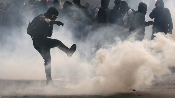 A protester kicks back a teargas grenade during a demonstration against French labour law reform in Paris, France, May 12, 2016. A protester kicks back a teargas grenade during a demonstration against French labour law reform in Paris, France, May 12, 2016. - Sputnik International