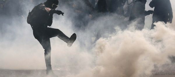 A protester kicks back a teargas grenade during a demonstration against French labour law reform in Paris, France, May 12, 2016. A protester kicks back a teargas grenade during a demonstration against French labour law reform in Paris, France, May 12, 2016. - Sputnik International