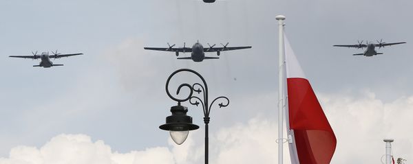 Polish Air Force C-130 Hercules aircraft fly over Poland's national flag during a military parade. Polish Air Force C-130 Hercules aircraft fly over Poland's national flag during a military parade. - Sputnik International