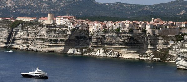 Boats sail off the cliffs of the city of Bonifacio, in the southern French Corsican island Boats sail off the cliffs of the city of Bonifacio, in the southern French Corsican island - Sputnik International
