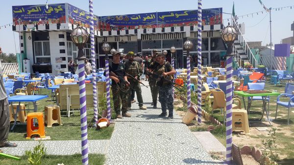 Shi'ite fighters are seen at a cafe where men, including fans of Spain's Real Madrid football club, had gathered, after an attack by gunmen in the predominately Shi'ite Muslim town of Balad, Iraq, May 13, 2016 - Sputnik International