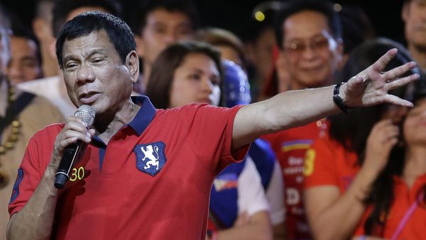 Philippine presidential race front-runner Davao city mayor Rodrigo Duterte gestures during his final campaign rally in Manila, Philippines on Saturday, May 7, 2016. - Sputnik International
