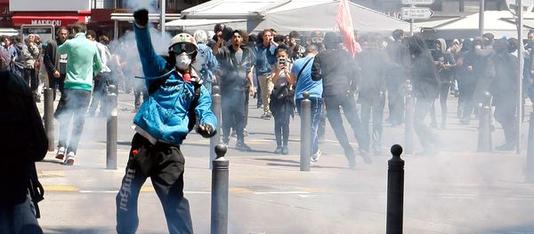 A masked demonstrator throws a tear gas canister during a clash with police, after a demonstration in Marseille, southern France, Thursday, May 12, 2016 A masked demonstrator throws a tear gas canister during a clash with police, after a demonstration in Marseille, southern France, Thursday, May 12, 2016 - Sputnik International