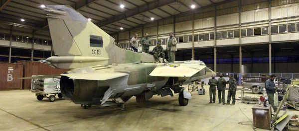 Engineers from the Libyan air force repair a MIG-23bn fighter jet at a military air base in the eastern coastal city of Benghazi on May 2, 2016 Engineers from the Libyan air force repair a MIG-23bn fighter jet at a military air base in the eastern coastal city of Benghazi on May 2, 2016 - Sputnik International