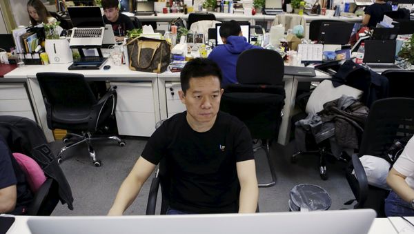 Jia Yueting, co-founder and head of Le Holdings Co Ltd, also known as LeEco and formerly as LeTV, uses a computer on a staff's seat as he poses for a photo (File) Jia Yueting, co-founder and head of Le Holdings Co Ltd, also known as LeEco and formerly as LeTV, uses a computer on a staff's seat as he poses for a photo (File) - Sputnik International