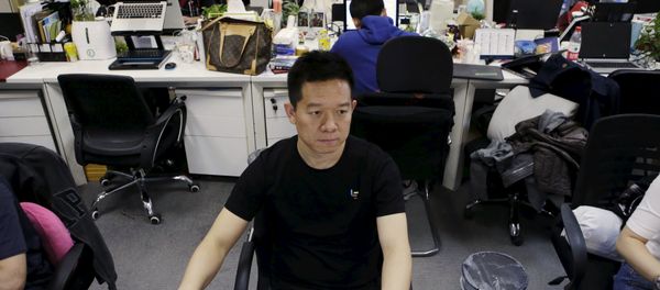 Jia Yueting, co-founder and head of Le Holdings Co Ltd, also known as LeEco and formerly as LeTV, uses a computer on a staff's seat as he poses for a photo (File) - Sputnik International