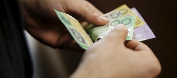 A customer counts his Australian dollar banknotes (File) A customer counts his Australian dollar banknotes (File) - Sputnik International