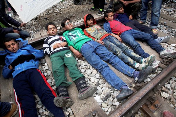 Boys lay on a railway track during a protest at a makeshift camp for refugees and migrants at the Greek-Macedonian border near the village of Idomeni, Greece, May 5, 2016. Boys lay on a railway track during a protest at a makeshift camp for refugees and migrants at the Greek-Macedonian border near the village of Idomeni, Greece, May 5, 2016. - Sputnik International