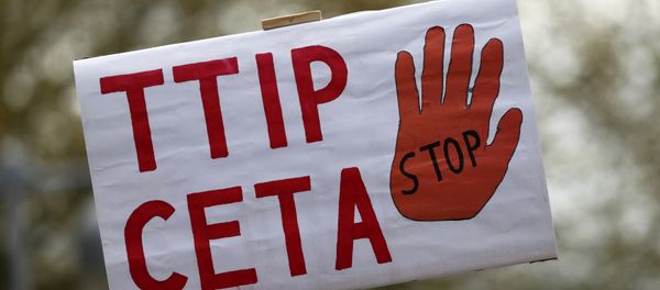 A placard against Comprehensive Economic and Trade Agreement (CETA) and Transatlantic Trade and Investment Partnership (TTIP) agreements. A placard against Comprehensive Economic and Trade Agreement (CETA) and Transatlantic Trade and Investment Partnership (TTIP) agreements. - Sputnik International