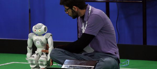 An Iranian sudent from Iran's Azad University of Qazvin checks a robot during the RoboCup Iran Open 2015, in Tehran, on April 8, 2015 An Iranian sudent from Iran's Azad University of Qazvin checks a robot during the RoboCup Iran Open 2015, in Tehran, on April 8, 2015 - Sputnik International