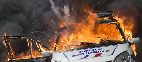A police car explodes after being set on fire during an unauthorized counter-demonstration against police violence on May 18, 2016 in Paris, as Police across France demonstrate today against the anti-cop hatred they say they have endured during a wave of anti-government protests since early March - Sputnik International