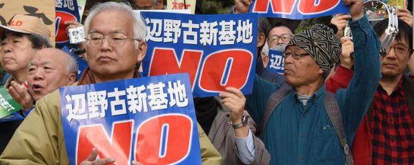 People hold banners as they listen to a speaker during a rally against a new US military base in Okinawa, Japan's nouthernmost prefecture (file) - Sputnik International