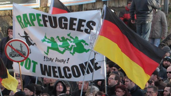 Right-wing demonstrators hold a sign Rapefugees not welcome - !Stay away! and a sign with a crossed out mosque as they march in Cologne, Germany Right-wing demonstrators hold a sign Rapefugees not welcome - !Stay away! and a sign with a crossed out mosque as they march in Cologne, Germany - Sputnik International