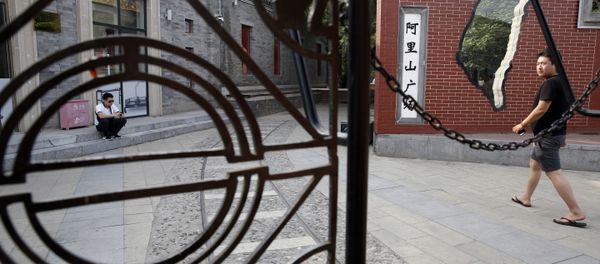 A man walks past a little used Taiwan themed retail district with an outline of the Taiwan island in Beijing Friday A man walks past a little used Taiwan themed retail district with an outline of the Taiwan island in Beijing Friday - Sputnik International