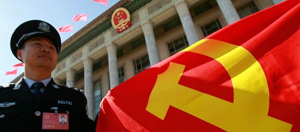 A Chinese policeman holds a Chinese Communist Party flag  - Sputnik International