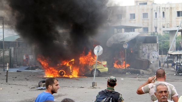 A Syrian army soldier and civilians inspect the damage after explosions hit the Syrian city of Tartous, in this handout picture provided by SANA on May 23, 2016. - Sputnik International