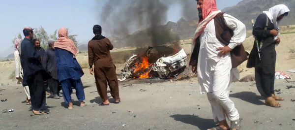This photograph taken on May 21, 2016 shows Pakistani local residents gathering around a destroyed vehicle hit by a drone strike in which Afghan Taliban Chief Mullah Akhtar Mansour was believed to be travelling in the remote town of Ahmad Wal in Balochistan, around 160 kilometres west of Quetta. - Sputnik International