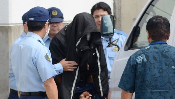 Policemen escort US citizen and former US Marine Kenneth Franklin Shinzato (C) to the prosecutor's office at Uruma Police Station in Uruma, Okinawa prefecture Policemen escort US citizen and former US Marine Kenneth Franklin Shinzato (C) to the prosecutor's office at Uruma Police Station in Uruma, Okinawa prefecture - Sputnik International