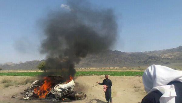 Pakistani local residents gathering around a destroyed vehicle hit by a drone strike in which Afghan Taliban Chief Mullah Akhtar Mansour was believed to be travelling in the remote town of Ahmad Wal in Balochistan, around 160 kilometres west of Quetta - Sputnik International