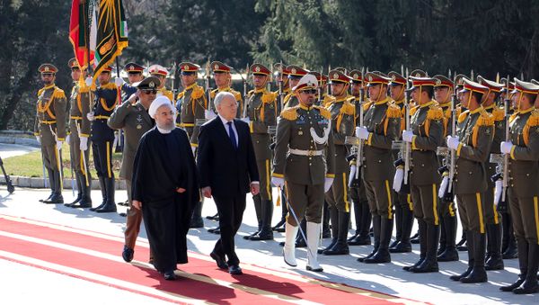 Iranian President Hassan Rouhani (L) walks next to Switzerland's President Johann Schneider during an official welcoming ceremony following the latter's arrival for talks, in the capital Tehran (File) - Sputnik International