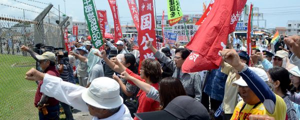 People raise their fists as they shout slogans to protest against the US military presence in front of the US Kadena Air Base in Cyatan, Okinawa prefecture, on May 21, 2016 People raise their fists as they shout slogans to protest against the US military presence in front of the US Kadena Air Base in Cyatan, Okinawa prefecture, on May 21, 2016 - Sputnik International