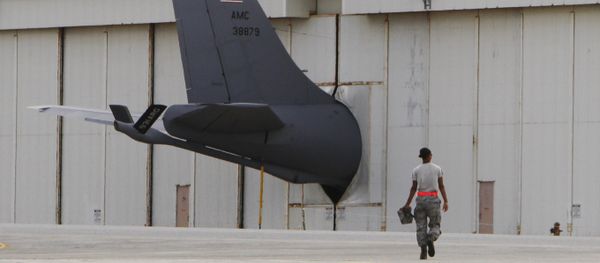 A ground crew member walks towards the tail of a U.S. Air Force KC-135 Stratotanker protruding from a hanger at Kadena Air Base on Japan's southwestern island of Okinawa (File) A ground crew member walks towards the tail of a U.S. Air Force KC-135 Stratotanker protruding from a hanger at Kadena Air Base on Japan's southwestern island of Okinawa (File) - Sputnik International
