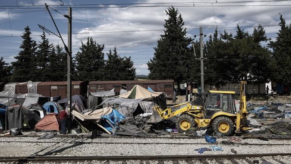 A bulldozer clears the debris at the site of the makeshift refugee and migrant camp in Idomeni close to the Greek-Macedonian border on May 25, 2016 - Sputnik International