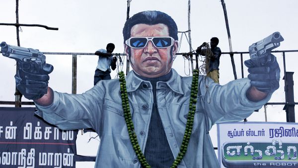Fans tie a sweet lemon garland onto a cut out of Tamil film actor Rajinikanth on the release of his latest film Endhiran (Robot) in Chennai on October 1, 2010 - Sputnik International