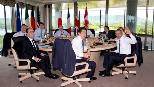 (Clockwise from left) British Prime Minister David Cameron, Canadian Prime Minister Justin Trudeau, European Commission President Jean-Claude Juncker, European Council President Donald Tusk, Italian Prime Minister Matteo Renzi, German Chancellor Angela Merkel, U.S. President Barack Obama, Japanese Prime Minister Shinzo Abe and French President Francois Hollande look to the media as they gather to participate in a G-7 Working Session in Shima, Japan, Friday, May 27, 2016, during the G-7 Summit - Sputnik International