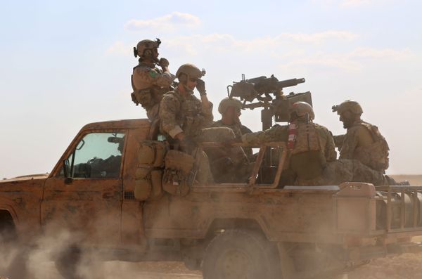 Armed men in uniform identified by Syrian Democratic forces as US special operations forces ride in the back of a pickup truck in the village of Fatisah in the northern Syrian province of Raqa on May 25, 2016 - Sputnik International