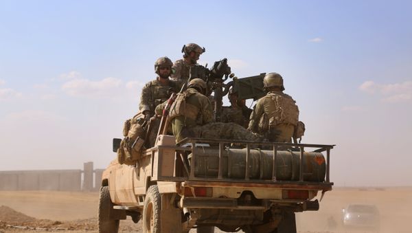 Armed men in uniform identified by Syrian Democratic forces as US special operations forces ride in the back of a pickup truck in the village of Fatisah in the northern Syrian province of Raqa on May 25, 2016 - Sputnik International