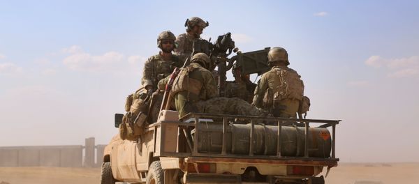 Armed men in uniform identified by Syrian Democratic forces as US special operations forces ride in the back of a pickup truck in the village of Fatisah in the northern Syrian province of Raqa on May 25, 2016 - Sputnik International
