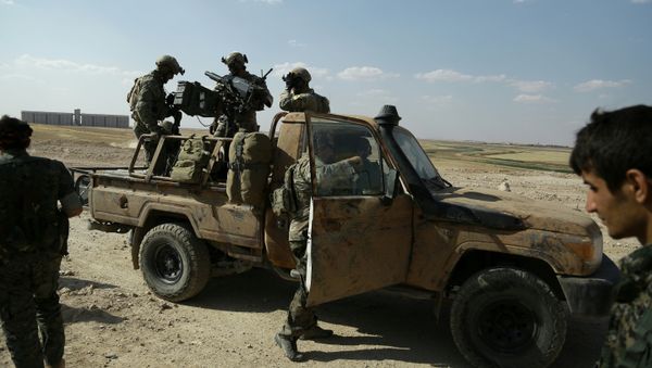 Armed men in uniforms identified by Syrian Democratic forces as US special operations forces stand in the back of a pickup truck in the village of Fatisah in the northern Syrian province of Raqa on May 25, 2016 - Sputnik International