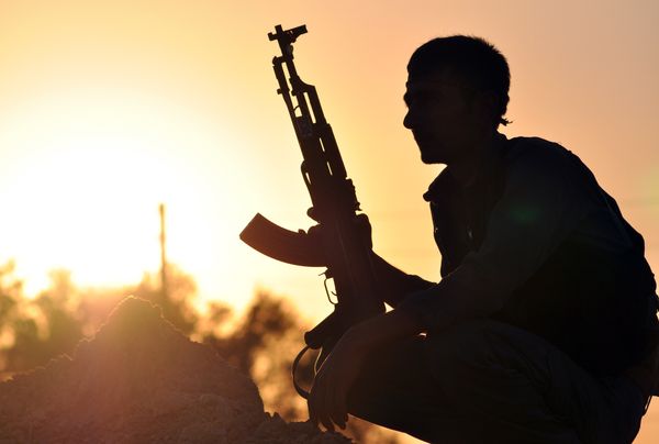 A fighter from the Kurdish People Protection Unit (YPG) poses for a photo at sunset in the Syrian town of Ain Issi, some 50 kilometres north of Raqqa, the self-proclaimed capital of the Islamic State (IS) group during clashes between IS group jihadists and YPG fighters on July 10, 2015 A fighter from the Kurdish People Protection Unit (YPG) poses for a photo at sunset in the Syrian town of Ain Issi, some 50 kilometres north of Raqqa, the self-proclaimed capital of the Islamic State (IS) group during clashes between IS group jihadists and YPG fighters on July 10, 2015 - Sputnik International