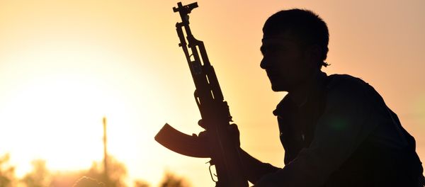 A fighter from the Kurdish People Protection Unit (YPG) poses for a photo at sunset in the Syrian town of Ain Issi, some 50 kilometres north of Raqqa, the self-proclaimed capital of the Islamic State (IS) group during clashes between IS group jihadists and YPG fighters on July 10, 2015 A fighter from the Kurdish People Protection Unit (YPG) poses for a photo at sunset in the Syrian town of Ain Issi, some 50 kilometres north of Raqqa, the self-proclaimed capital of the Islamic State (IS) group during clashes between IS group jihadists and YPG fighters on July 10, 2015 - Sputnik International
