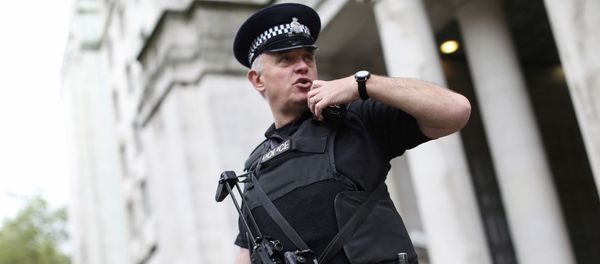 An armed police officer speaks on his radio as he patrols near the Ministry of Defence in London, Britain May 11, 2016 - Sputnik International