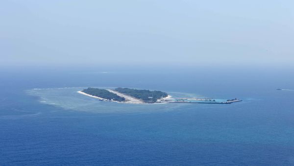 An aerial photo taken though a glass window of a Taiwanese military plane shows the view of Itu Aba, which the Taiwanese call Taiping, at the South China Sea, March 23, 2016 - Sputnik International