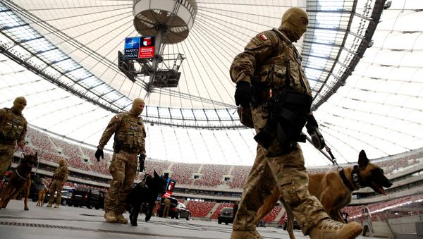 Soldiers walk after demonstration of their skills during a military police exercise before the NATO summit in July in Warsaw at the PGE National Stadium in Warsaw, Poland May 24, 2016 Soldiers walk after demonstration of their skills during a military police exercise before the NATO summit in July in Warsaw at the PGE National Stadium in Warsaw, Poland May 24, 2016 - Sputnik International
