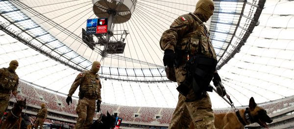 Soldiers walk after demonstration of their skills during a military police exercise before the NATO summit in July in Warsaw at the PGE National Stadium in Warsaw, Poland May 24, 2016 - Sputnik International