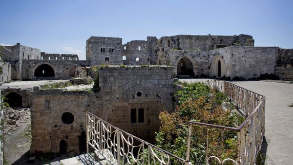 Crac des Chevaliers, the world's best preserved medieval Crusader castle, above the destroyed Sunni village of Hosn in Syria. Crac des Chevaliers, the world's best preserved medieval Crusader castle, above the destroyed Sunni village of Hosn in Syria. - Sputnik International