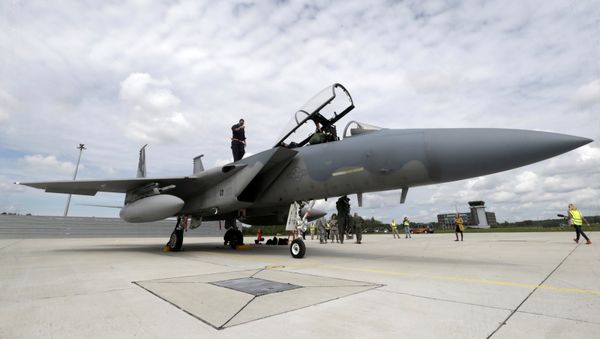 A specialist inspects a U.S Air Force F-15 Eagle fighter after a certification of the arresting gear in the military air base in Lielvarde, Latvia, May 19, 2016. - Sputnik International