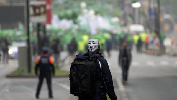A man watches as protesters begin to march during a demonstration against proposed working regulations in Brussels on Tuesday, May 31, 2016. - Sputnik International