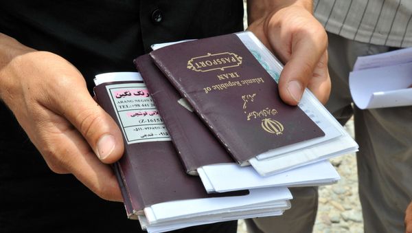 Iranian truck drivers collect their passports for border control near the Armenian town of Agarak on July 12, 2012 next to the border with Iran, in a region where the borders of Armenia, Azerbaijan, Iran and Turkey join. - Sputnik International