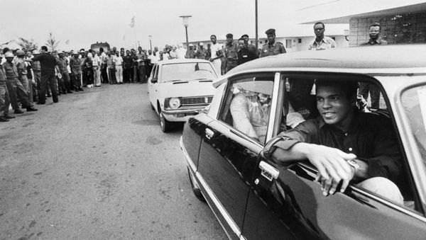 This file photo taken on September 28, 1974 shows former world heavyweight champion Muhammad Ali being welcomed by a cheering crowd in Kinshasa, Zaire, before his world heavyweight championship fight against titleholder US George Foreman on October 30, 1974 - Sputnik International