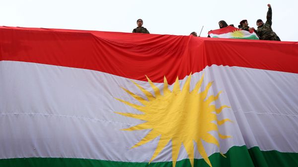 Iraqi Kurdish youths wave a national flag - Sputnik International