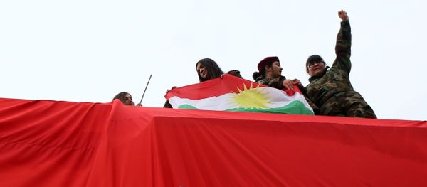 Iraqi Kurdish youths wave a national flag Iraqi Kurdish youths wave a national flag - Sputnik International