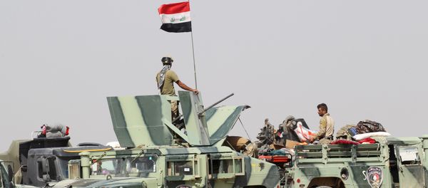 Iraqi security forces sit in military vehicles in the Nuaimiya suburb of Fallujah, Iraq - Sputnik International