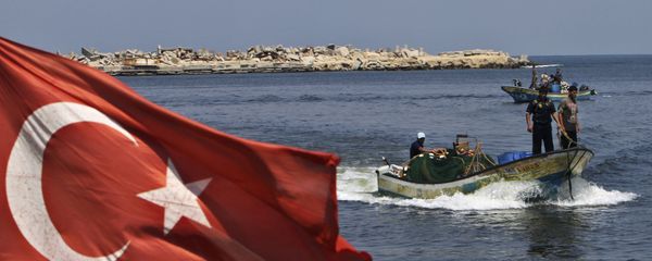 A Turkish flag hangs in the Gaza port as fishermen in their boats pass off the shore of Gaza City, Tuesday, Sept. 13, 2011 - Sputnik International