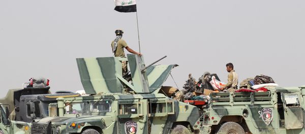 Iraqi security forces sit in military vehicles in suburb of Fallujah, Iraq Iraqi security forces sit in military vehicles in suburb of Fallujah, Iraq - Sputnik International