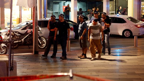 Israeli security personnel secure the area where a shooting attack took place in the center of Tel Aviv. Israeli security personnel secure the area where a shooting attack took place in the center of Tel Aviv. - Sputnik International